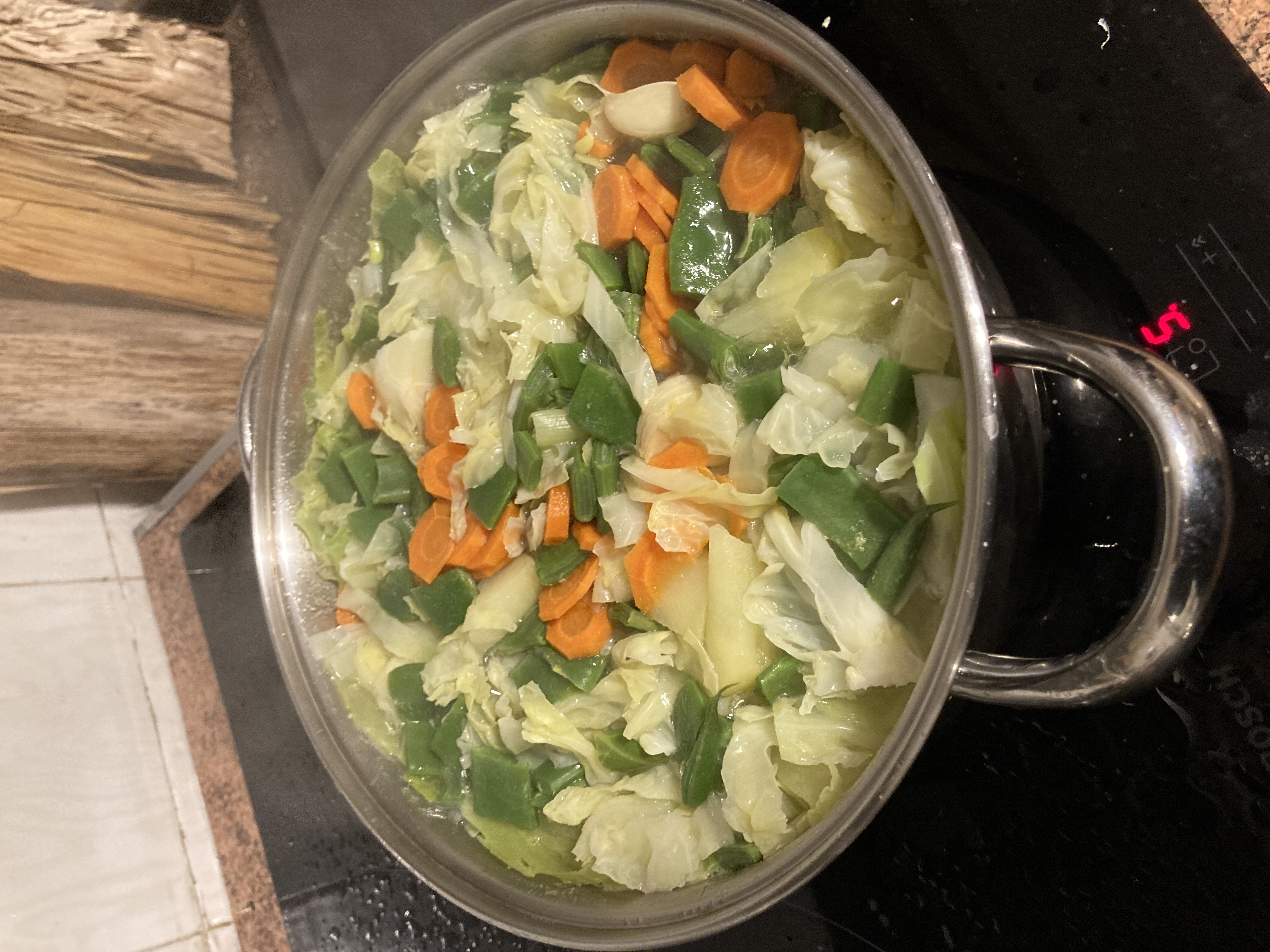 vegetable stew in a pot, carrots, cale, potatoes, string beans