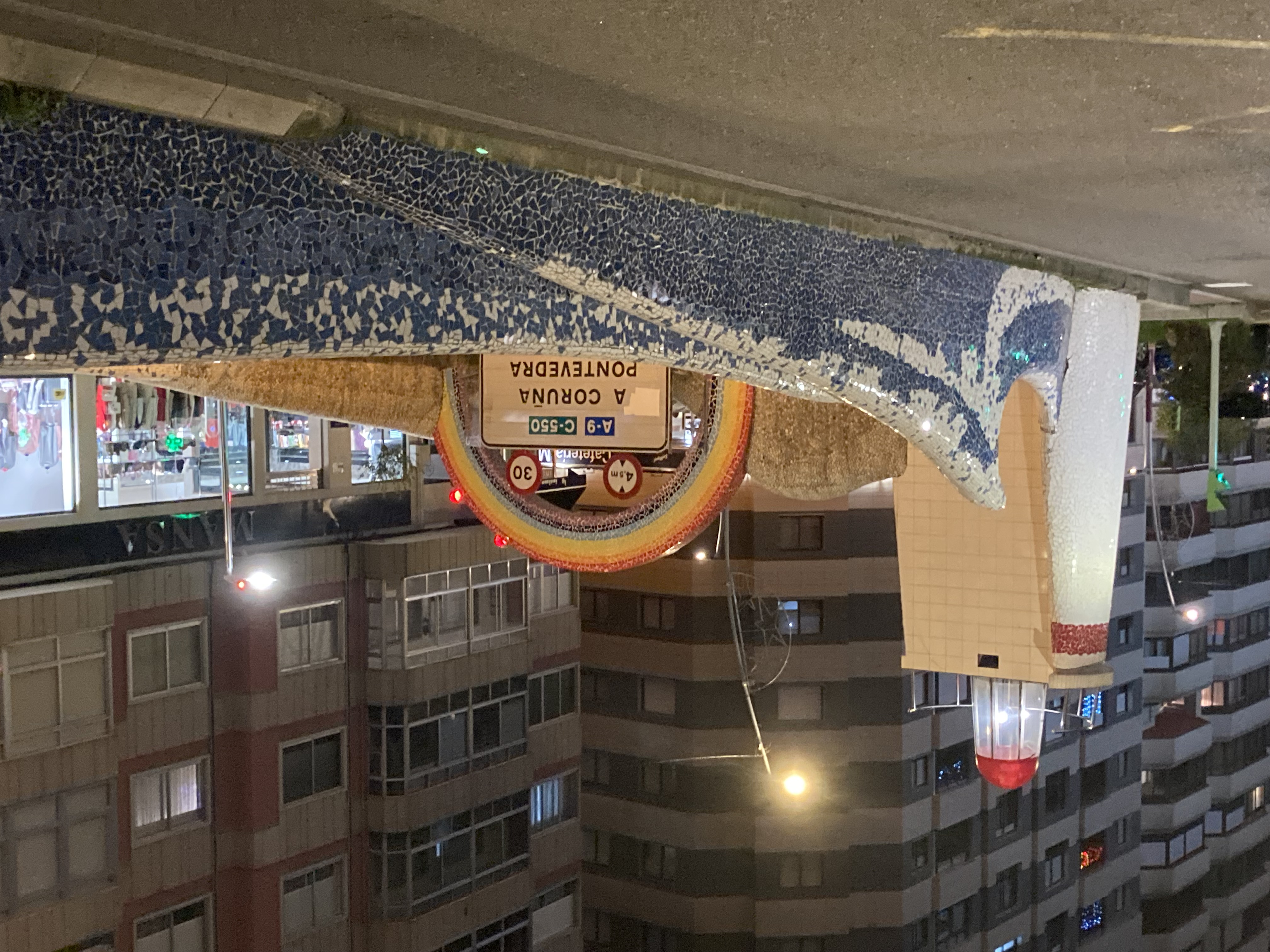 mosaic decorating the entrance of a highway with a wave, a lighthouse and a rainbow
